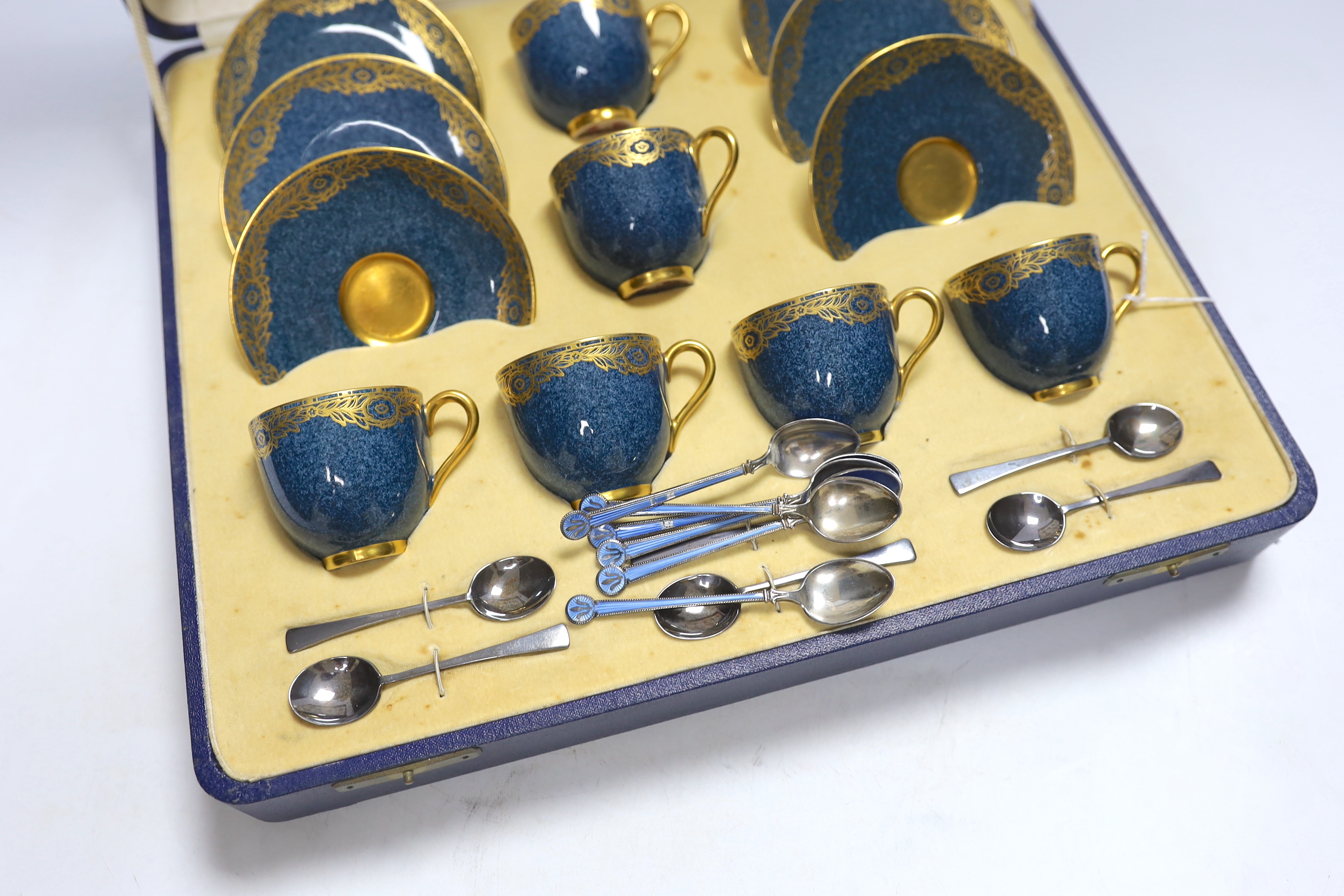 A cased Royal Worcester gilt and powder blue six piece coffee set with silver teaspoons, set of six silver and guilloche enamel teaspoons together with a Meissen blue and white ‘onion pattern’ serving dish, 39cm wide